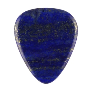 May include: A dark blue guitar pick made of lapis lazuli with gold flecks throughout.