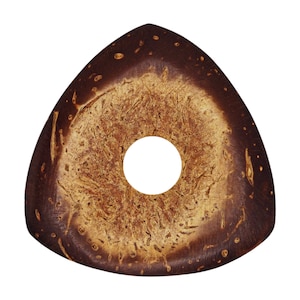 May include: A brown and tan coconut shell guitar pick with a round hole in the center.