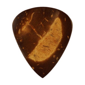 May include: A brown and tan coconut shell guitar pick. The pick is shaped like a triangle with rounded edges.