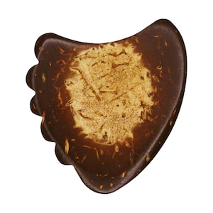 May include: A brown and tan gua sha tool with a unique shape. The tool has a smooth, curved design with a textured center. The gua sha tool is made of a natural material and is designed for facial massage and skincare.