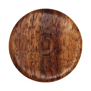 May include: A round wooden coaster with a dark brown wood grain pattern. The coaster has a slightly raised center.