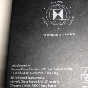 May include: Dark grey background featuring a white graphic of a globe with arrows and the words "REUSE", "REPURPOSE", and "RECYCLE". The text "RESPONSIBLY CRAFTED" is below the graphic. The image also contains text with manufacturing information.