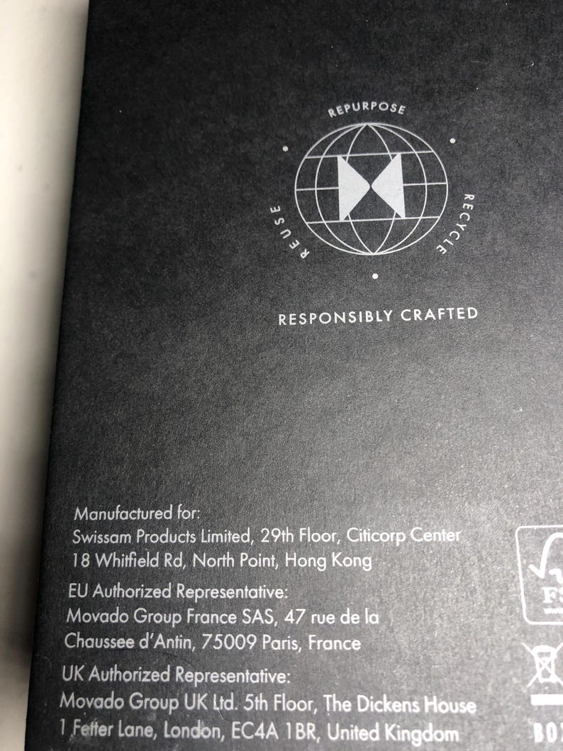 May include: Dark grey background featuring a white graphic of a globe with arrows and the words "REUSE", "REPURPOSE", and "RECYCLE". The text "RESPONSIBLY CRAFTED" is below the graphic. The image also contains text with manufacturing information.