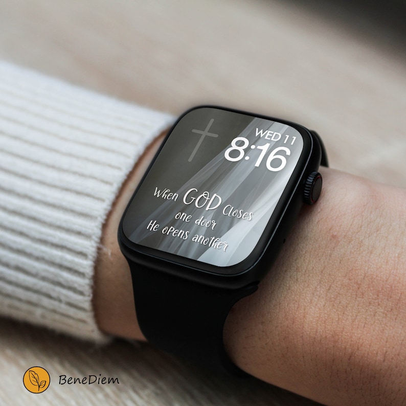 May include: A black smartwatch with a white face displaying the time 8:16 and the date WED 11. The watch face also has a white cross and a quote that reads "When GOD closes one door He opens another."