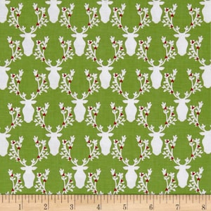 May include: Green fabric with a white repeating pattern of stylized reindeer heads with antlers. The antlers are adorned with small red berries and white leaves.