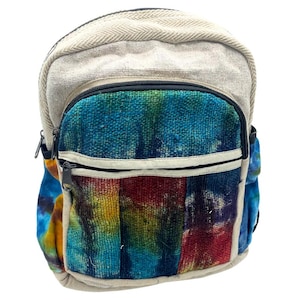 May include: A small backpack with a colorful, tie-dye design on the front pocket. The backpack has a beige top and straps, with a black zipper and a small side pocket. The front pocket features a mix of blue, green, yellow, and red hues.