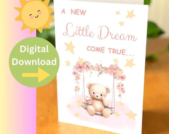 May include: A digital download of a greeting card with a pink and white background. The card features a teddy bear sitting on a swing with pink flowers. The text on the card reads "A new little dream come true..."