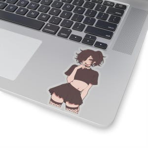 May include: A sticker featuring a cartoon illustration of a person with short, dark hair wearing a black crop top, a black skirt, and fishnet stockings. The person is holding their hand to their chin and looking at the viewer.