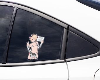 May include: A vinyl decal applied to a car window featuring an anime-style character with blonde hair, cow ears, and horns. The character wears a cow-print bikini and arm sleeves, makes a peace sign, and holds a sign with the text "FREE MILK".