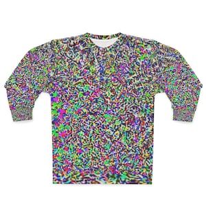 Può includere: Una felpa a maniche lunghe con un vivace motivo statico multicolore. Il design presenta un mix caotico di colori, tra cui verde, rosa, blu e giallo, creando un'estetica visivamente dinamica e astratta. La felpa ha uno scollo tondo e polsini a coste.