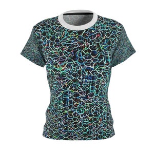 May include: A short-sleeved t-shirt with a distinctive pattern. It has a white crew neck and a design of interconnected, irregular shapes in black, blue, green, and red. The pattern covers the entire shirt, including the sleeves.