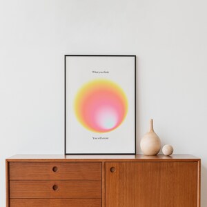 May include: A framed print with a yellow, pink, and white gradient circle in the center. The text "What you think" is above the circle and "You will create" is below the circle.