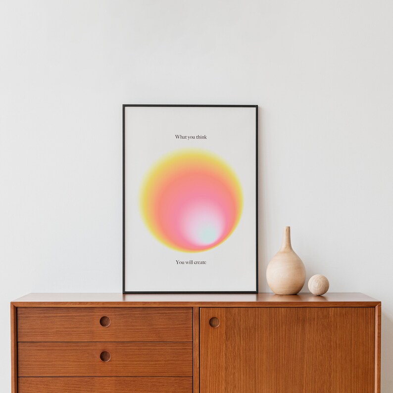 May include: A framed print with a yellow, pink, and white gradient circle in the center. The text "What you think" is above the circle and "You will create" is below the circle.