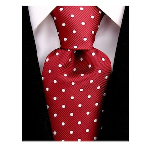 May include: A red tie with white polka dots. The tie is made of a silky material and has a classic design.