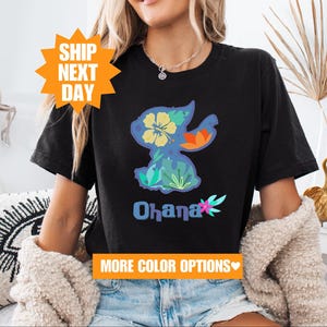 a woman sitting on a couch wearing a black shirt