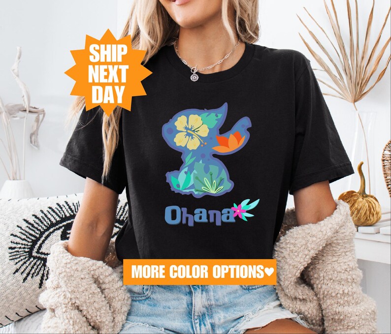 a woman sitting on a couch wearing a black shirt