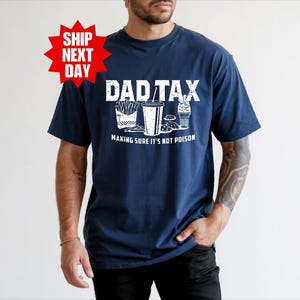 a man wearing a t - shirt that says dad tax making sure it's