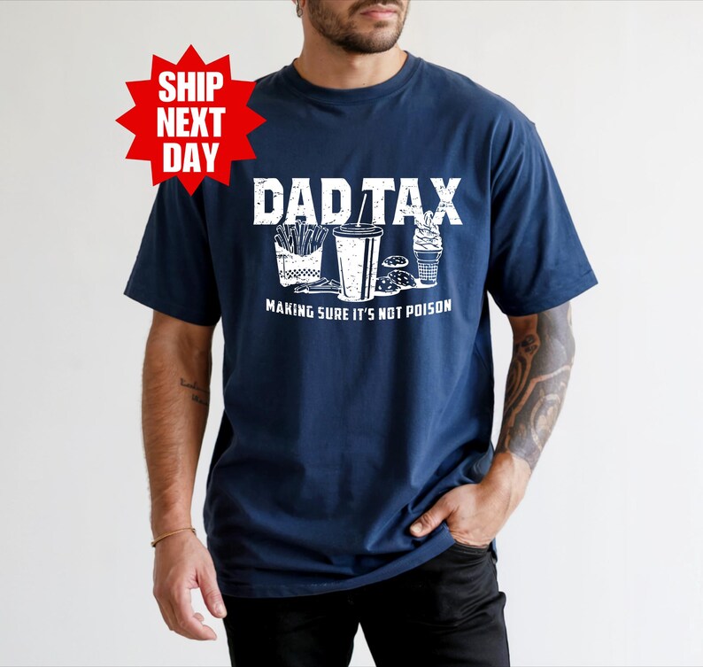 a man wearing a t - shirt that says dad tax making sure it's
