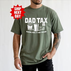 a man wearing a shirt that says dadtax