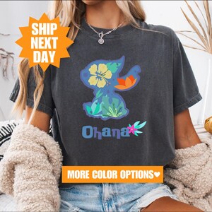 a woman wearing a black shirt with the word ohana on it