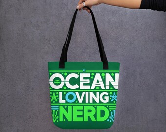 May include: Green tote bag with black handles and the text "Ocean Loving Nerd" in white, green, and blue. The text is surrounded by small images of sea life.