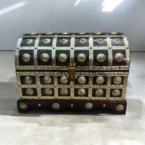 A genuinely hand-crafted wooden treasure chest with aged brass hardware — the kind of statement storage piece that makes a room look like it belongs in a seafarer's study.