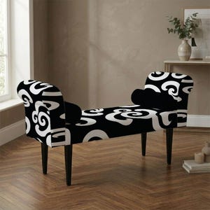 May include: A black and white bench with a curved backrest and armrests on both sides. The upholstery features a bold, repeating abstract swirl pattern. The bench is supported by four tapered black wooden legs, providing a stable base.