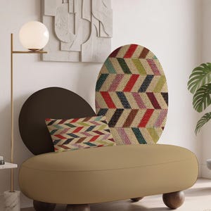 May include: A beige upholstered bench with a low profile and rounded dark wood feet. It features a dark brown circular backrest, a tall oval back panel with a multi-coloured chevron pattern, and a rectangular throw pillow with the same pattern.