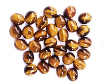 Könnte beinhalten: Eine Sammlung ovaler Tigeraugen-Edelsteine. Die Steine sind eine Mischung aus goldbraunen und schwarzen Farben mit einem schimmernden Effekt.