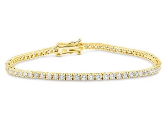 May include: A gold tennis bracelet with a row of small, clear gemstones. The bracelet has a secure clasp and is set against a white background. The bracelet is a classic piece of jewelry.