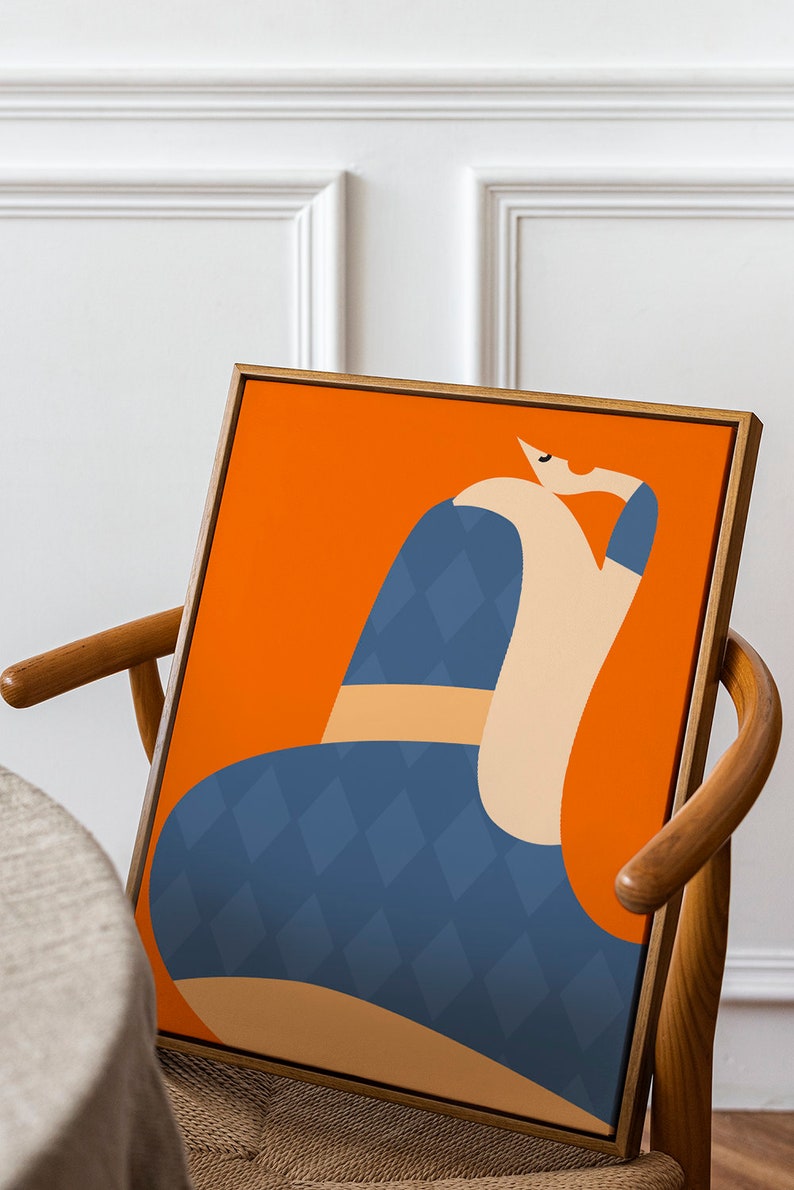 May include: Abstract art print depicting a seated figure. The artwork has a bright orange background with a figure in blue diamond pattern and beige tones. The framed art is displayed on a wooden chair.