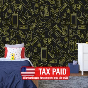 May include: Black wallpaper featuring a repeating pattern of yellow outline drawings of various video game controllers and handheld consoles. A bed with blue bedding and pillows is in front of the wallpaper. A white nightstand is on the right.