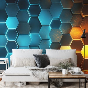 May include: A white sofa with two cushions and a throw blanket sits in front of a wall with a geometric pattern of blue and orange hexagons.