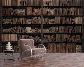 May include: A cozy reading nook featuring a plush, taupe armchair with gold accents, a small side table, and a decorative vase. The backdrop is a large bookshelf filled with vintage books, creating a warm and inviting atmosphere.