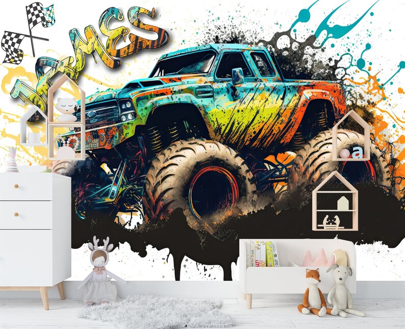 May include: A colorful monster truck with the word "James" written in graffiti style on a white background with black splatters of paint.