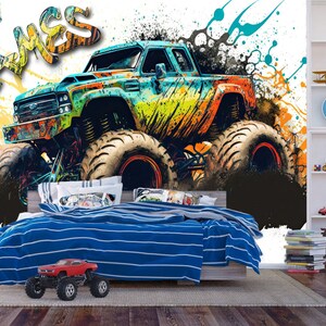 May include: A colorful monster truck with the name "James" written in graffiti style on a white background. The truck is surrounded by splashes of paint in various colors, including blue, green, yellow, and orange.