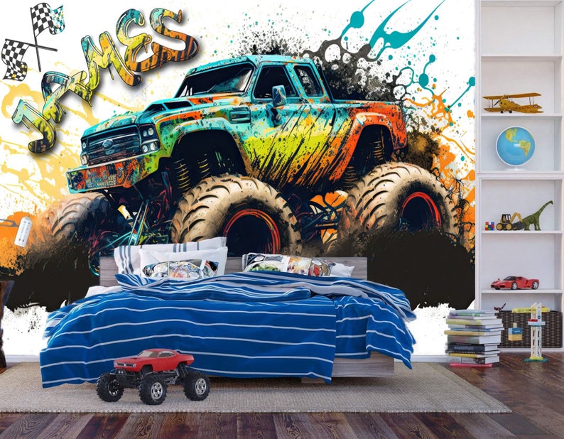 May include: A colorful monster truck with the name "James" written in graffiti style on a white background. The truck is surrounded by splashes of paint in various colors, including blue, green, yellow, and orange.