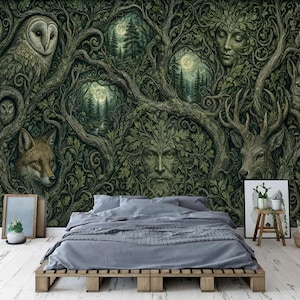 May include: A wall mural featuring a dark, intricate forest scene with a central face formed from leaves, surrounded by an owl, a fox, a deer, a rabbit, and a human face integrated into tree branches, set behind a bed with grey bedding.