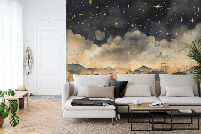May include: A white sectional sofa with a black throw blanket sits in front of a wall mural depicting a city skyline at night with gold stars and clouds.