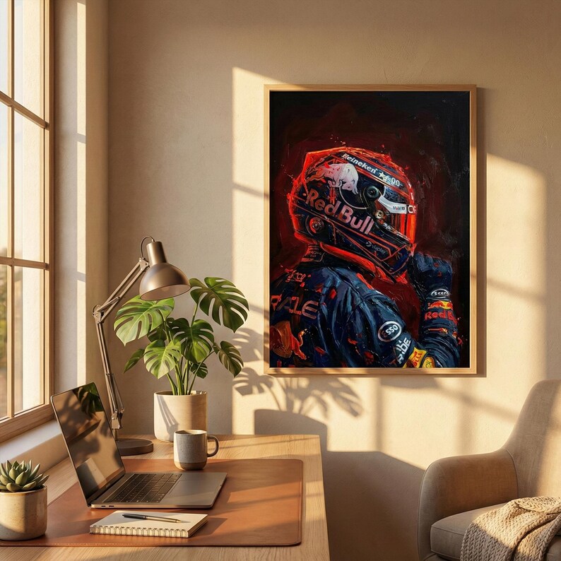 May include: A framed artwork featuring a Formula 1 driver in a Red Bull racing suit and helmet. The artwork is dominated by red and blue hues, with the Red Bull logo prominently displayed on the helmet and suit. The image has a dark, artistic style.