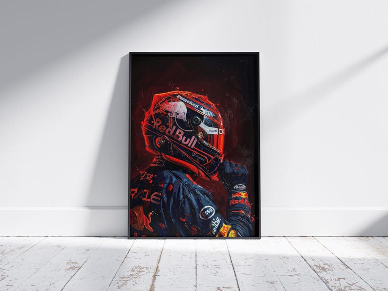 May include: Framed artwork featuring a Formula 1 driver in a Red Bull racing suit and helmet. The portrait is rendered in dark, dramatic colors, with the Red Bull logo prominently displayed on the helmet and suit. The artwork is set against a white wall.