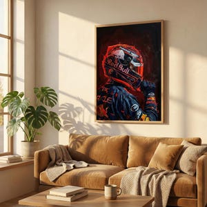 May include: A framed art print featuring a Formula 1 driver in a Red Bull racing suit and helmet. The artwork has a dark, dramatic style with red and blue tones. The Red Bull logo is prominently displayed on the helmet.