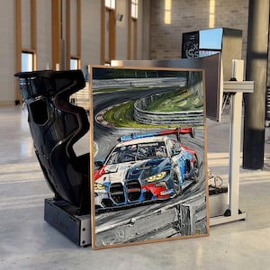 May include: A rectangular framed painting depicting a BMW Motorsport race car navigating a curved track. The artwork features thick, textured brushstrokes in shades of blue, red, and white, capturing the vehicle in motion on the asphalt.
