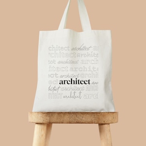 May include: White canvas tote bag with the word "architect" repeated in different fonts and sizes. The word "architect" is in bold black font.