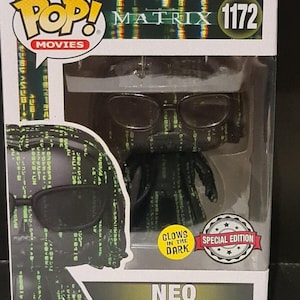 May include: A Funko Pop! Movies vinyl figure of Neo from The Matrix, wearing sunglasses and a long coat. The box features the movie title, the number 1172, and a "Special Edition" sticker. The figure glows in the dark.
