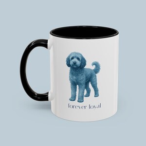 May include: White ceramic mug with a black handle and interior. The mug features a blue illustration of a dog and the text "forever loyal" in a dark blue font. The mug is a standard size.