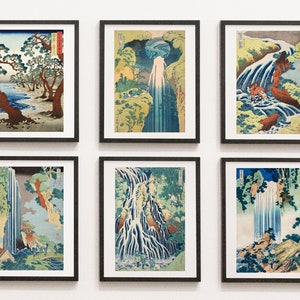 May include: Six framed prints of Japanese woodblock prints depicting waterfalls in various styles. The prints are in black frames and are arranged in a grid pattern on a white wall.
