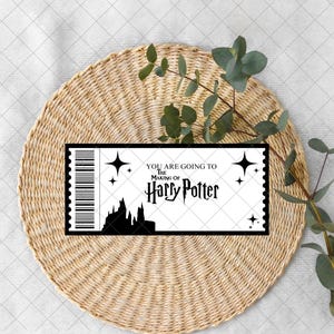 May include: A black and white ticket design with the text "YOU ARE GOING TO The Making Of Harry Potter". The ticket features a barcode, stars, and a silhouette of a castle. The ticket is on a woven, circular placemat.
