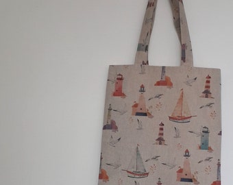 Nautical tote bag in boat and lighthouse print ideal for the seaside
