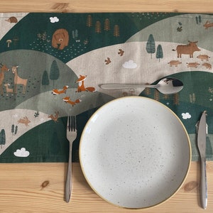 Fox table runner featuring bears, deer and foxes in green countryside